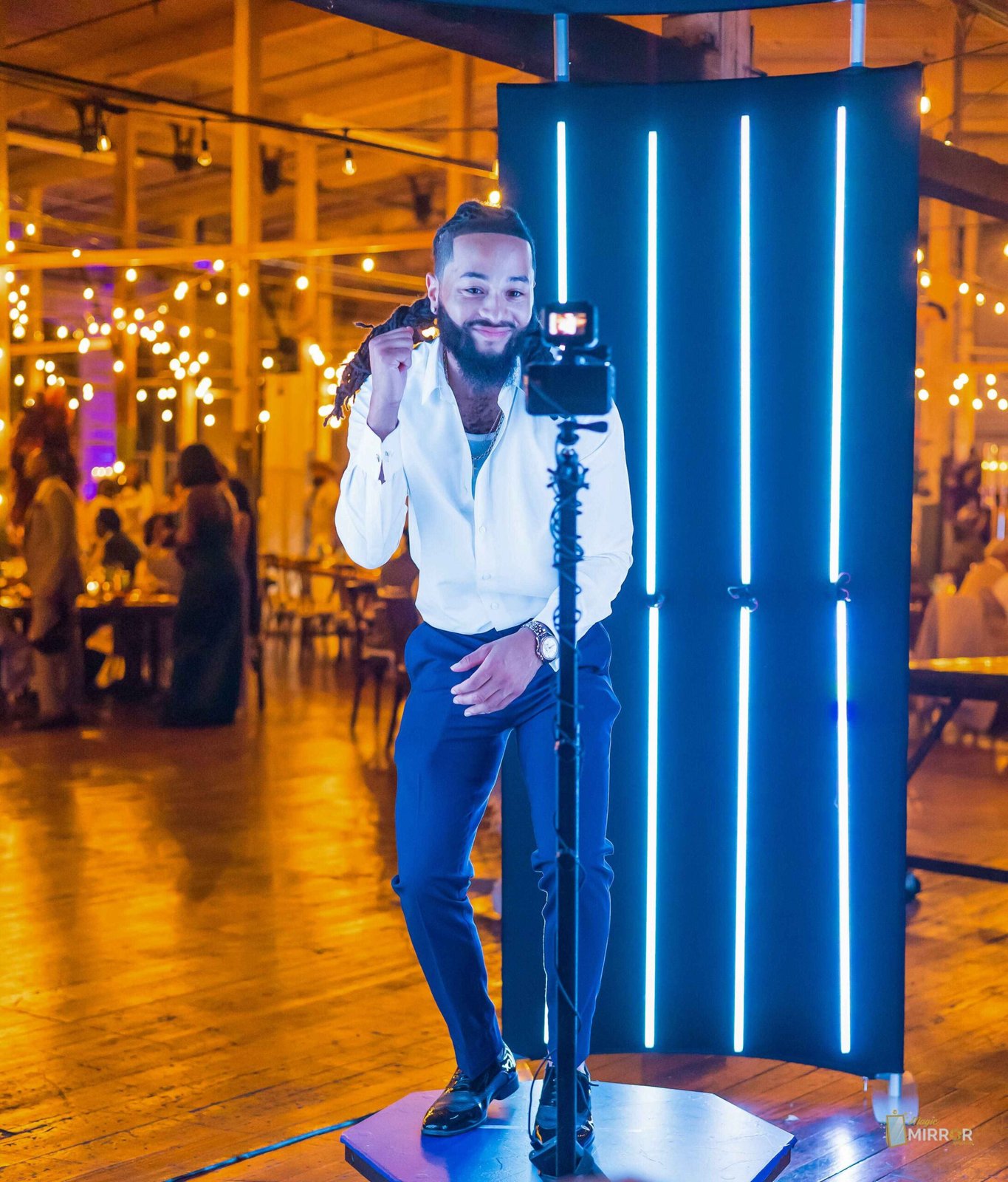 Guest posing on the 360 platform beside the LED tower