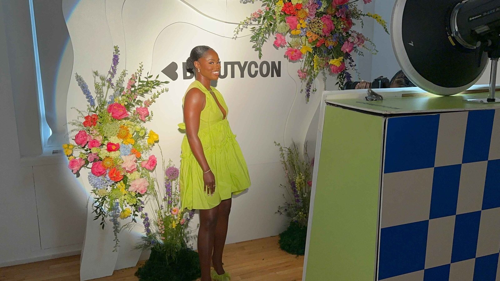 Beautycon branded photo booth with floral styling
