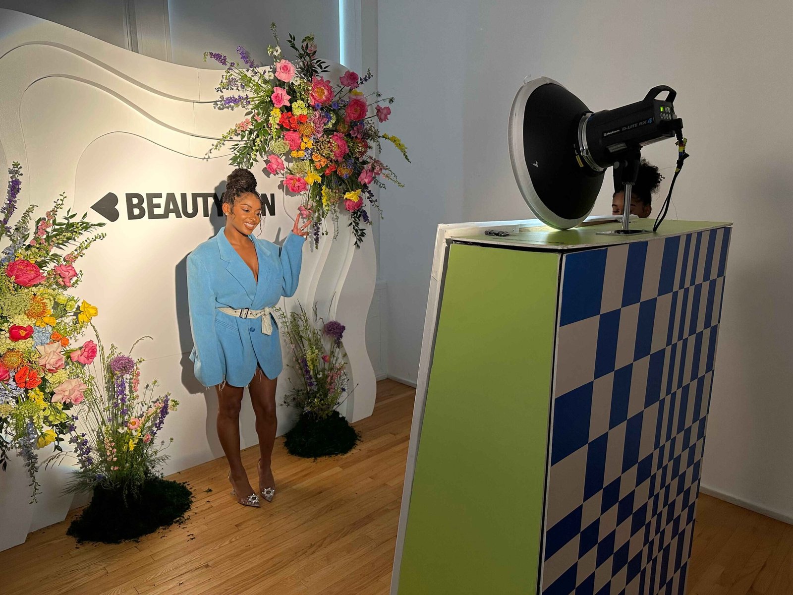 Guest posing at the Beautycon checkered photo booth