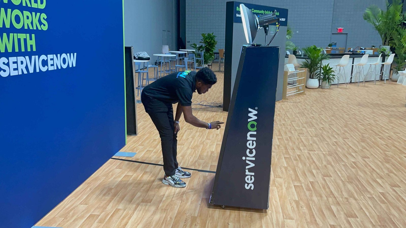 Team setting up a branded booth at the ServiceNow conference