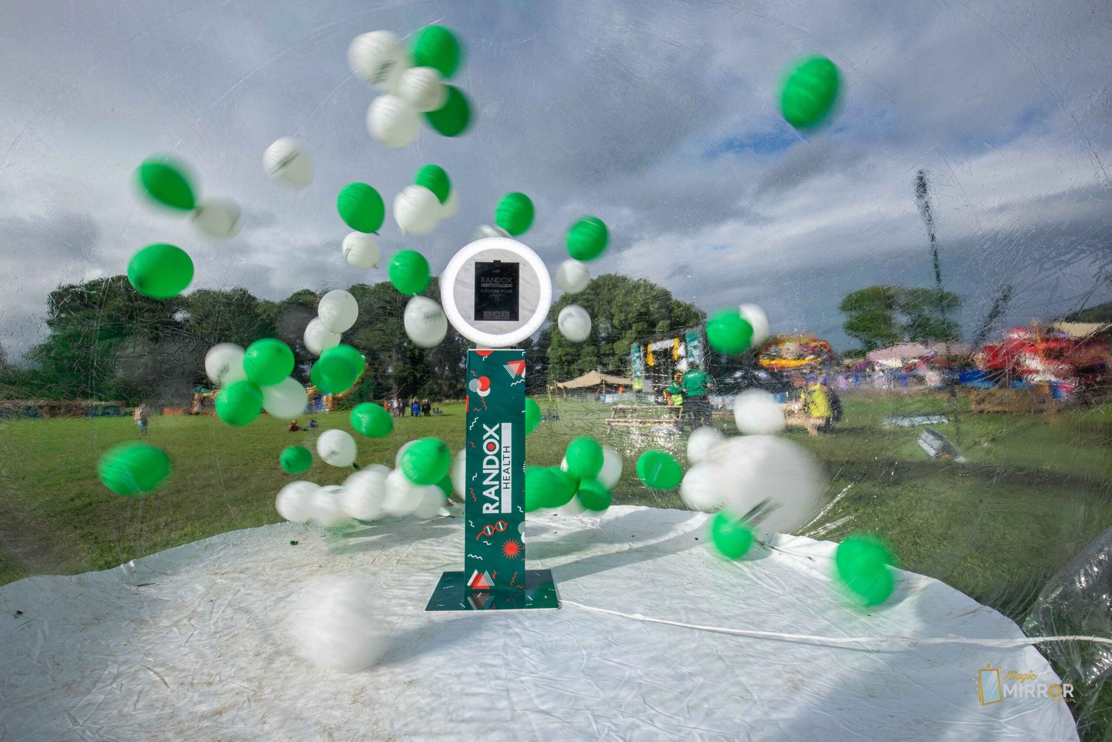 Randox-branded outdoor booth with balloons at a festival activation