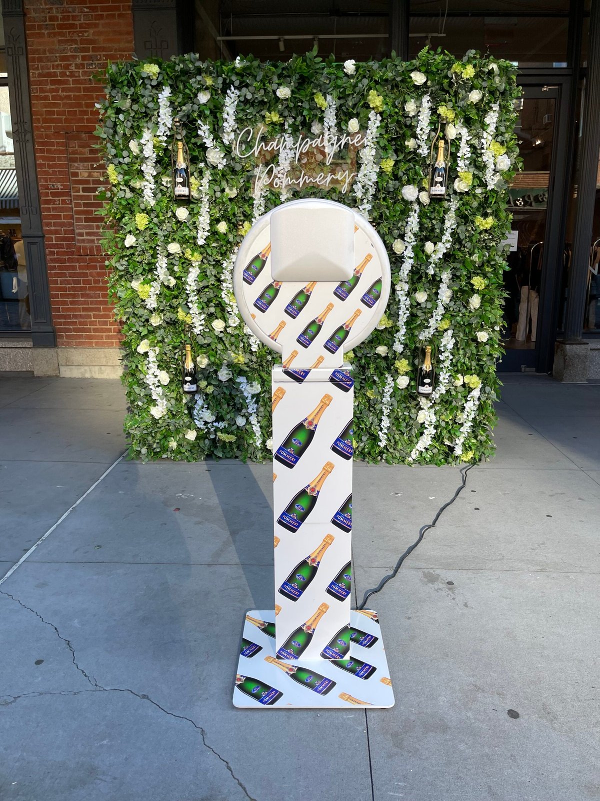 Champagne bottle display stand at an outdoor event