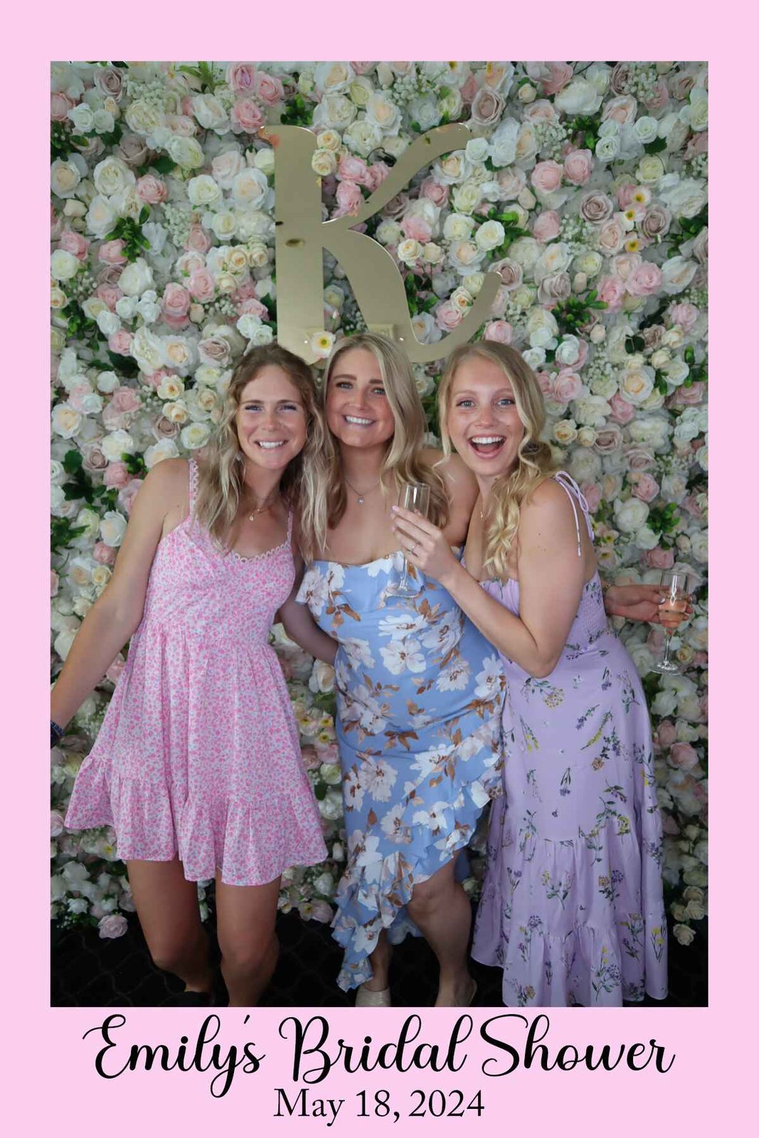 Friends laughing at the champagne wall celebration