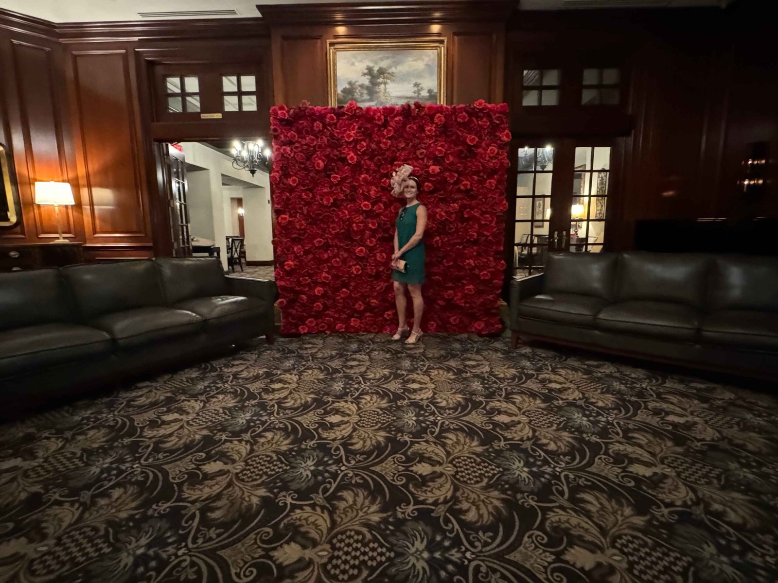 Red flower wall styled in a wood-paneled lounge