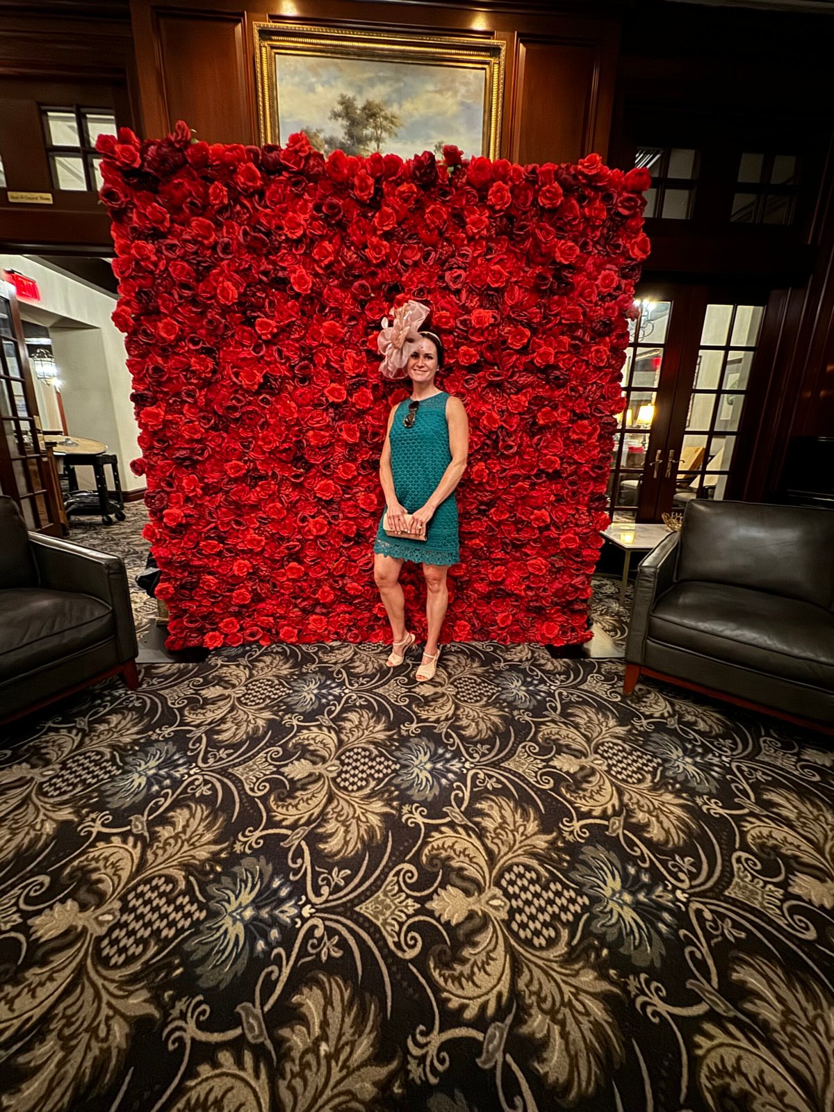 Guest at the red flower wall in a hotel lounge
