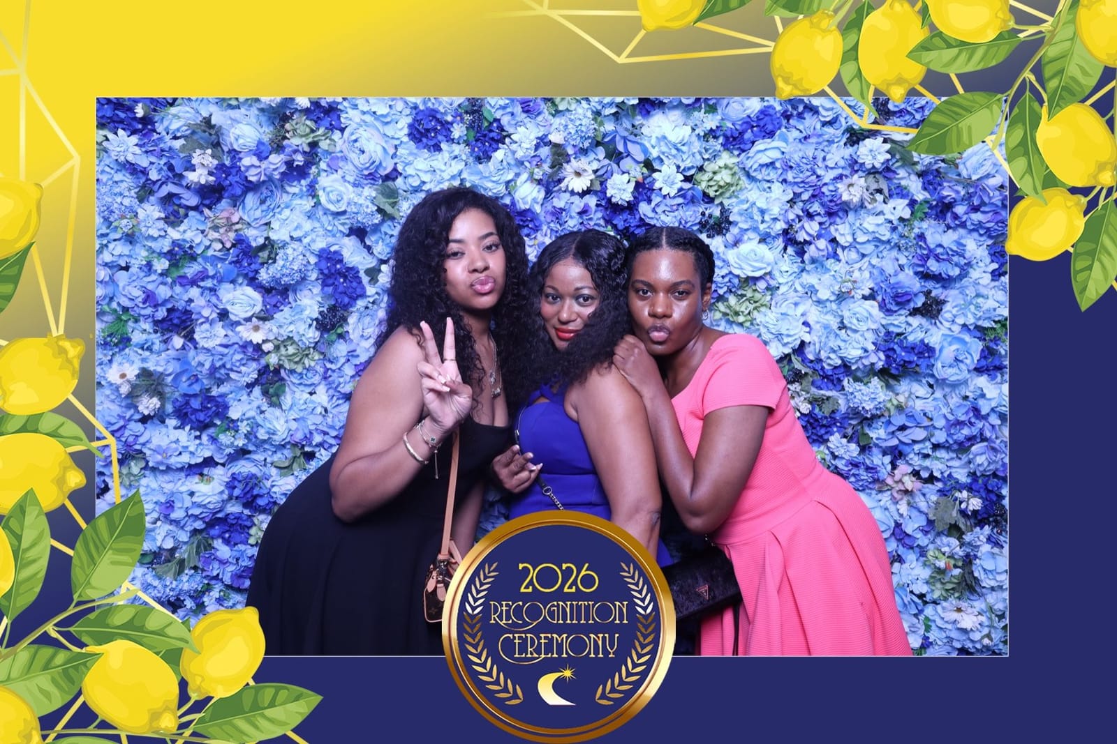 Guests striking a pose at the blue flower wall photo booth