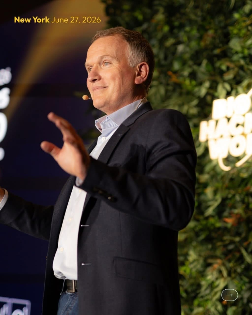 Keynote speaker in front of the hedge wall at a New York conference