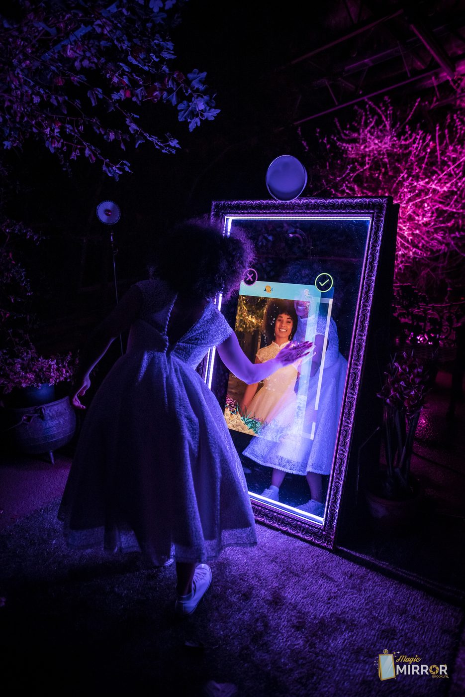 Guest using the interactive mirror photo booth touchscreen at an NYC event