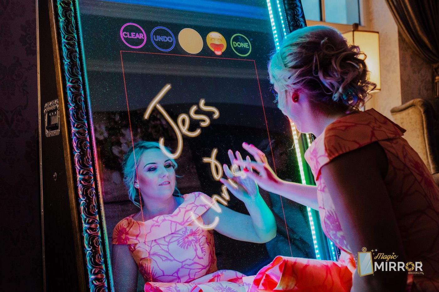 Party guests posing together at the LED-lit photo booth in New York City