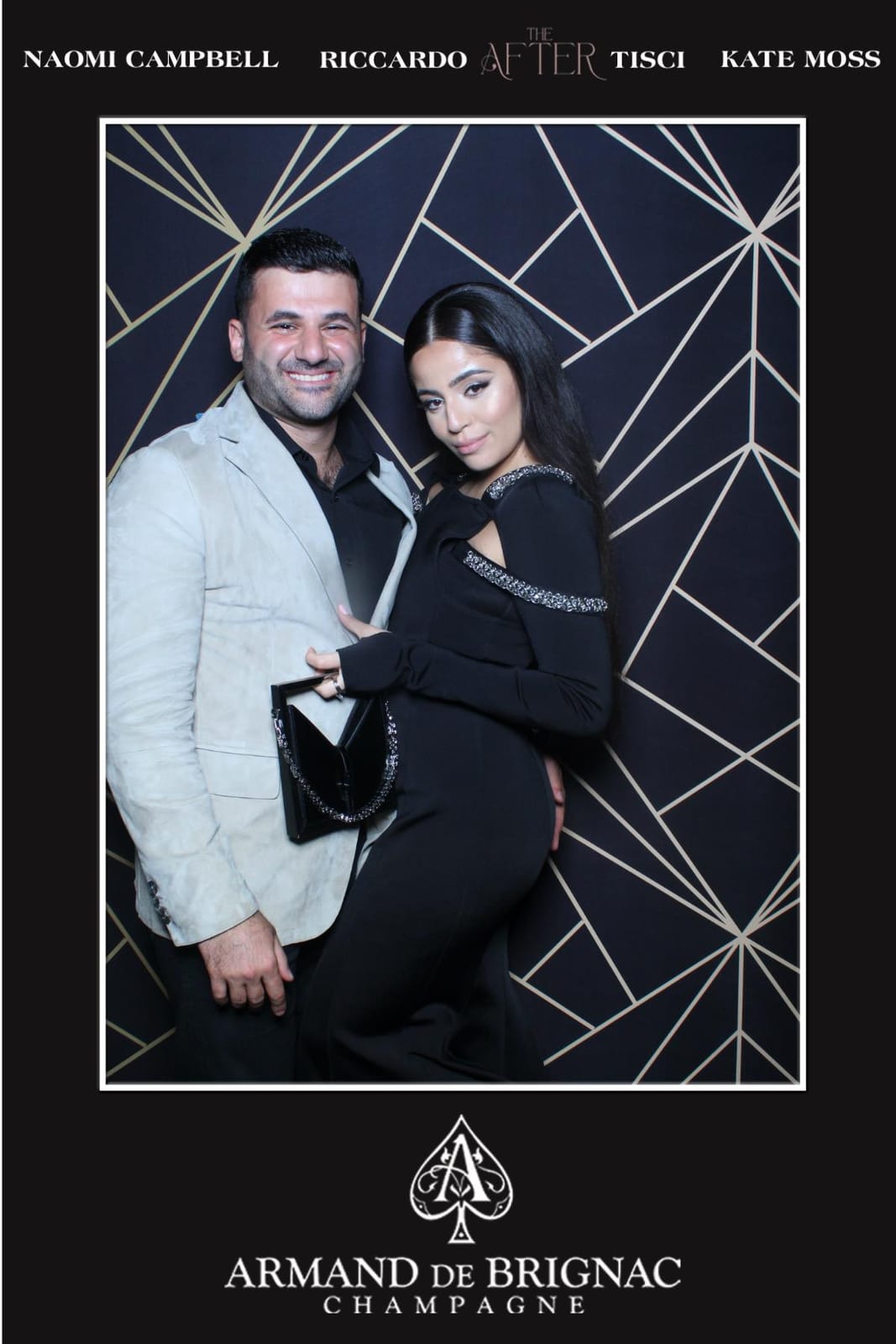 Couple posing at the Armand de Brignac champagne after-party photo booth