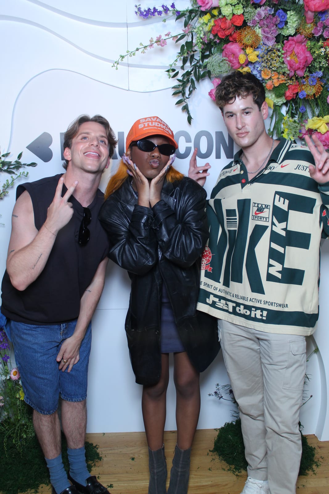 Three friends posing at the Beautycon convention photo booth
