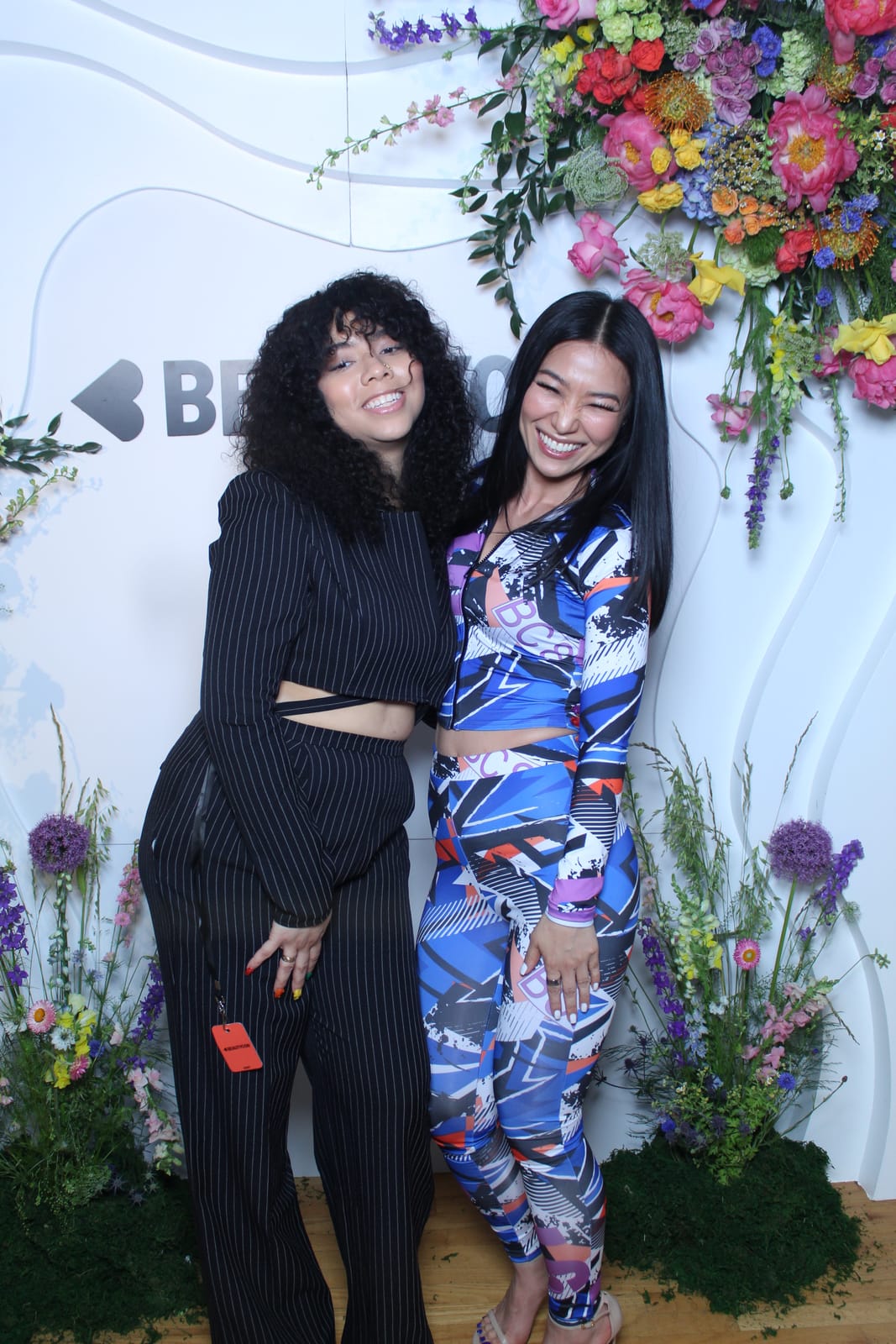 Two attendees in printed outfits at the Beautycon photo booth
