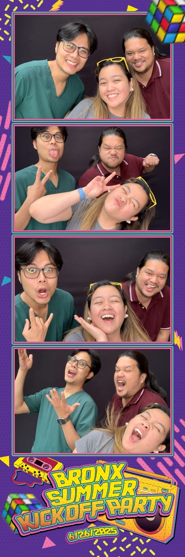 Three coworkers goofing around in the booth at the Bronx Summer Kickoff Party