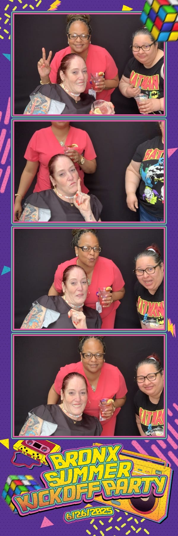 Three colleagues with drinks posing at the Bronx Summer Kickoff Party booth