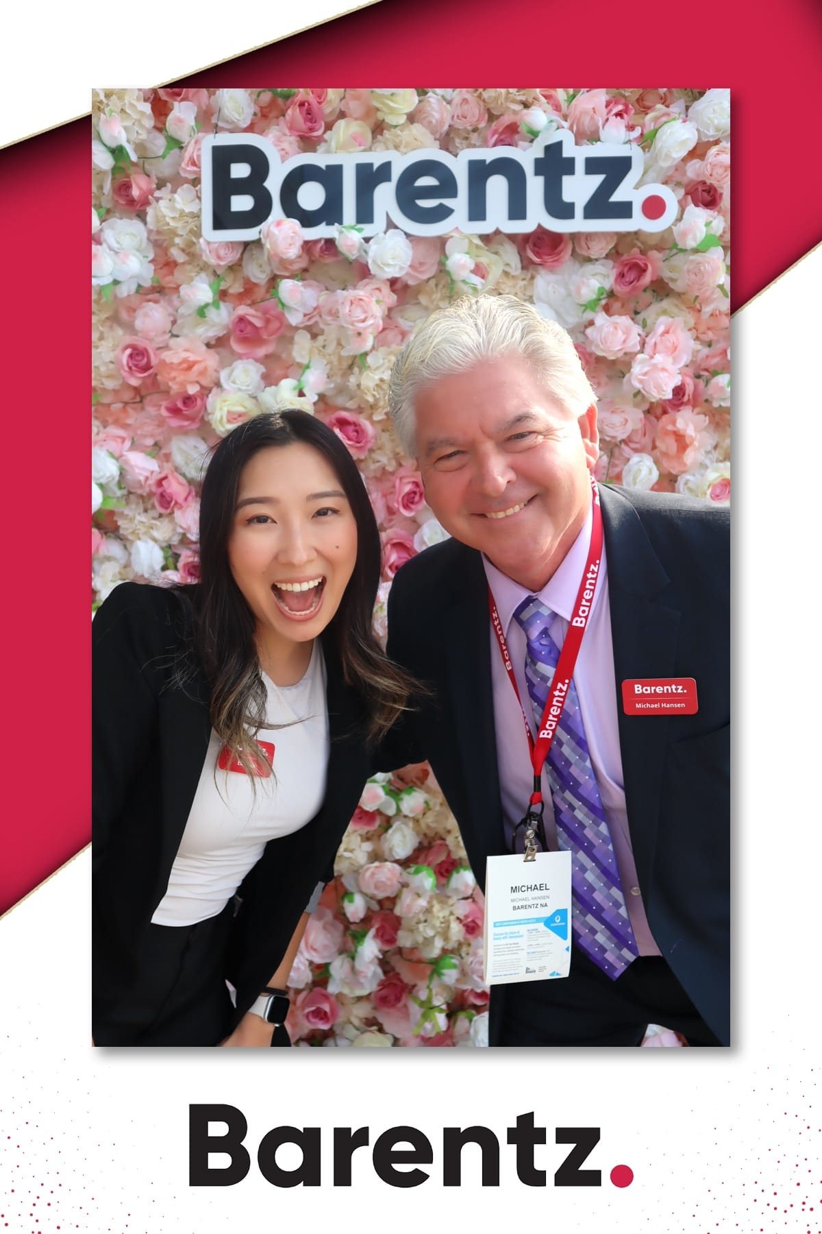 Two Barentz team members laughing at the NYSCC 2025 Suppliers' Day — pink flower wall with custom logo sign