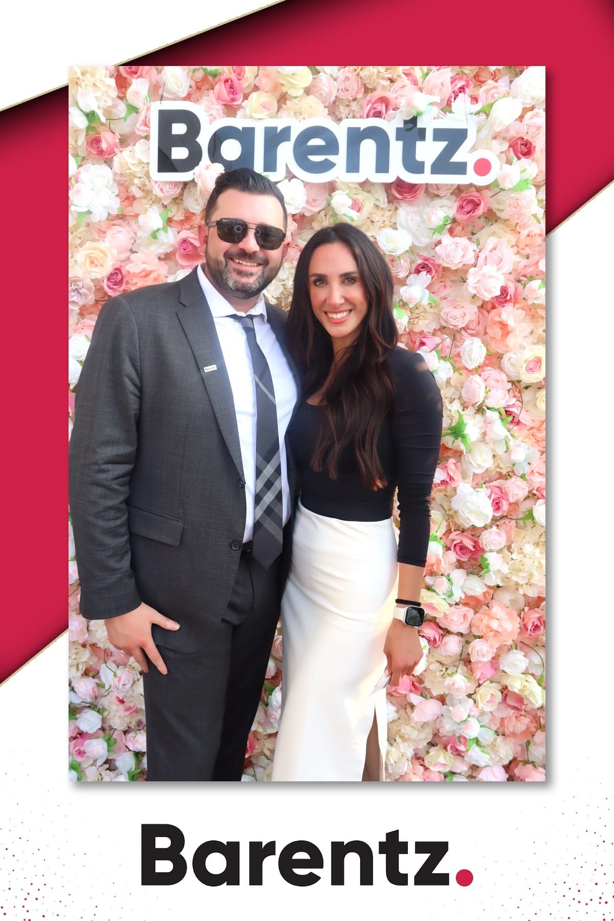 Couple posing at the Barentz branded flower wall at NYSCC 2025