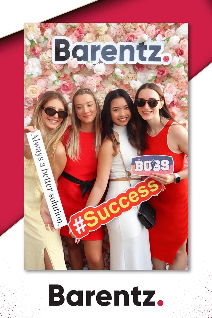 Four guests with Success and solution props at the Barentz flower wall