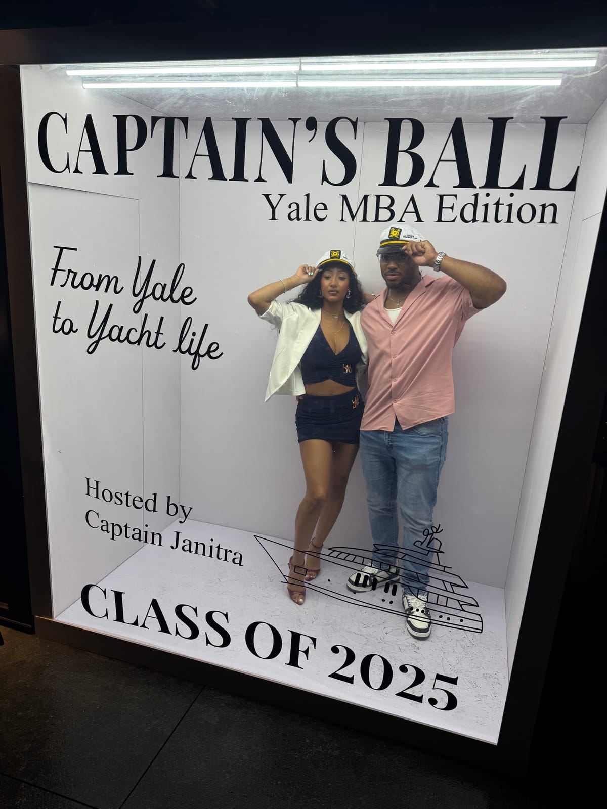 Guests posing at the Captain's Ball Yale MBA Edition sign