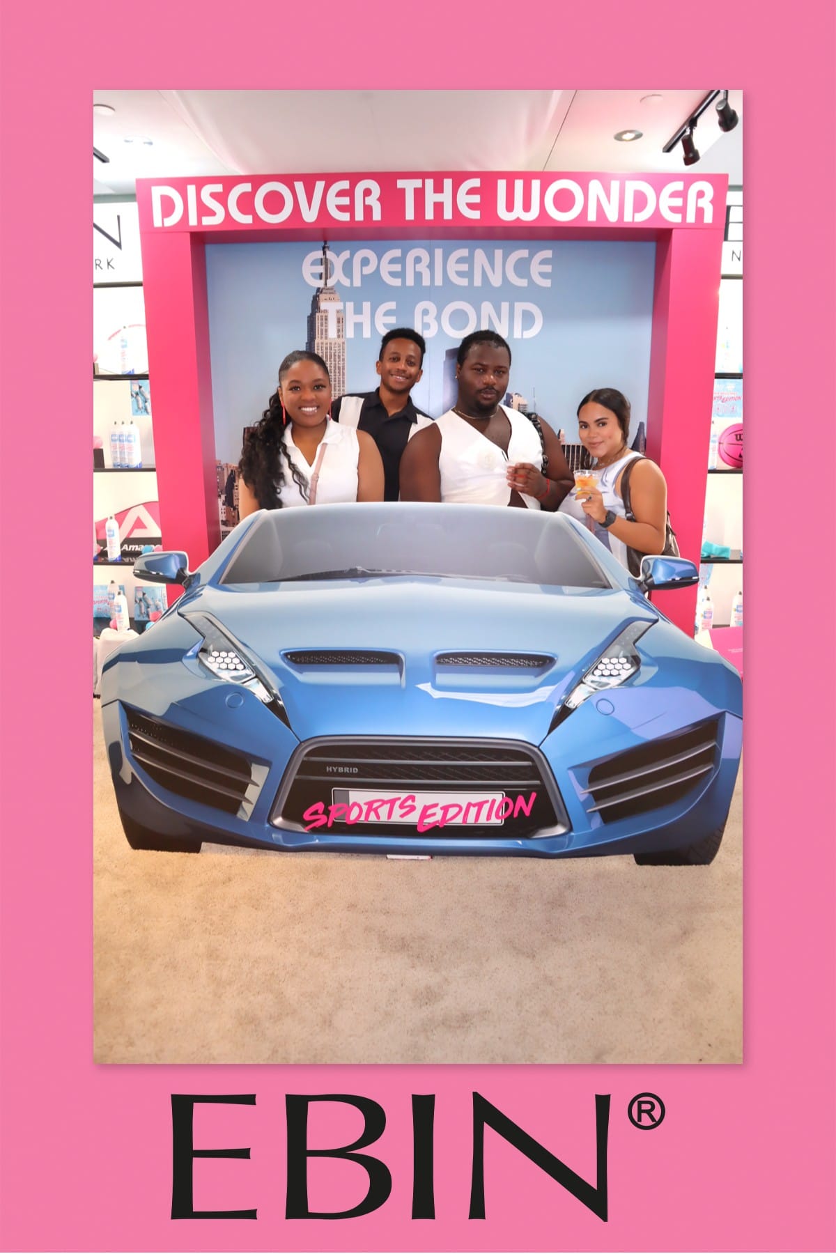 Family group posing at the EBIN New York Discover the Wonder sports-car backdrop