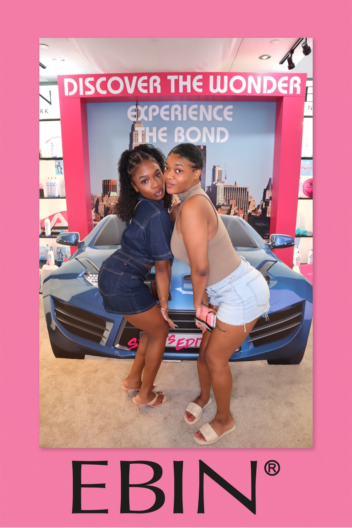Two friends posing back to back at the EBIN New York photo booth