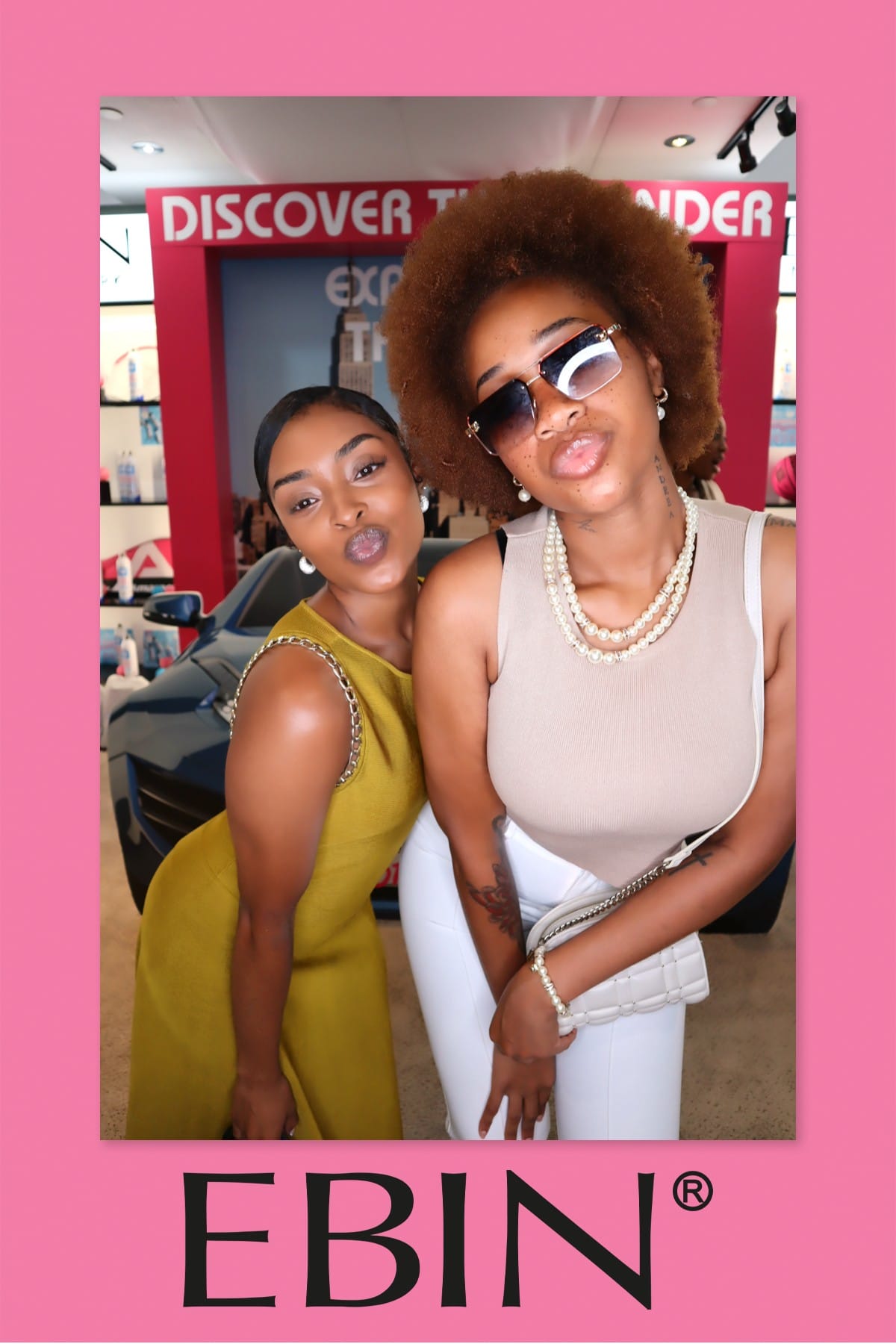 Two friends posing close together at the EBIN New York activation, pearl necklace detail