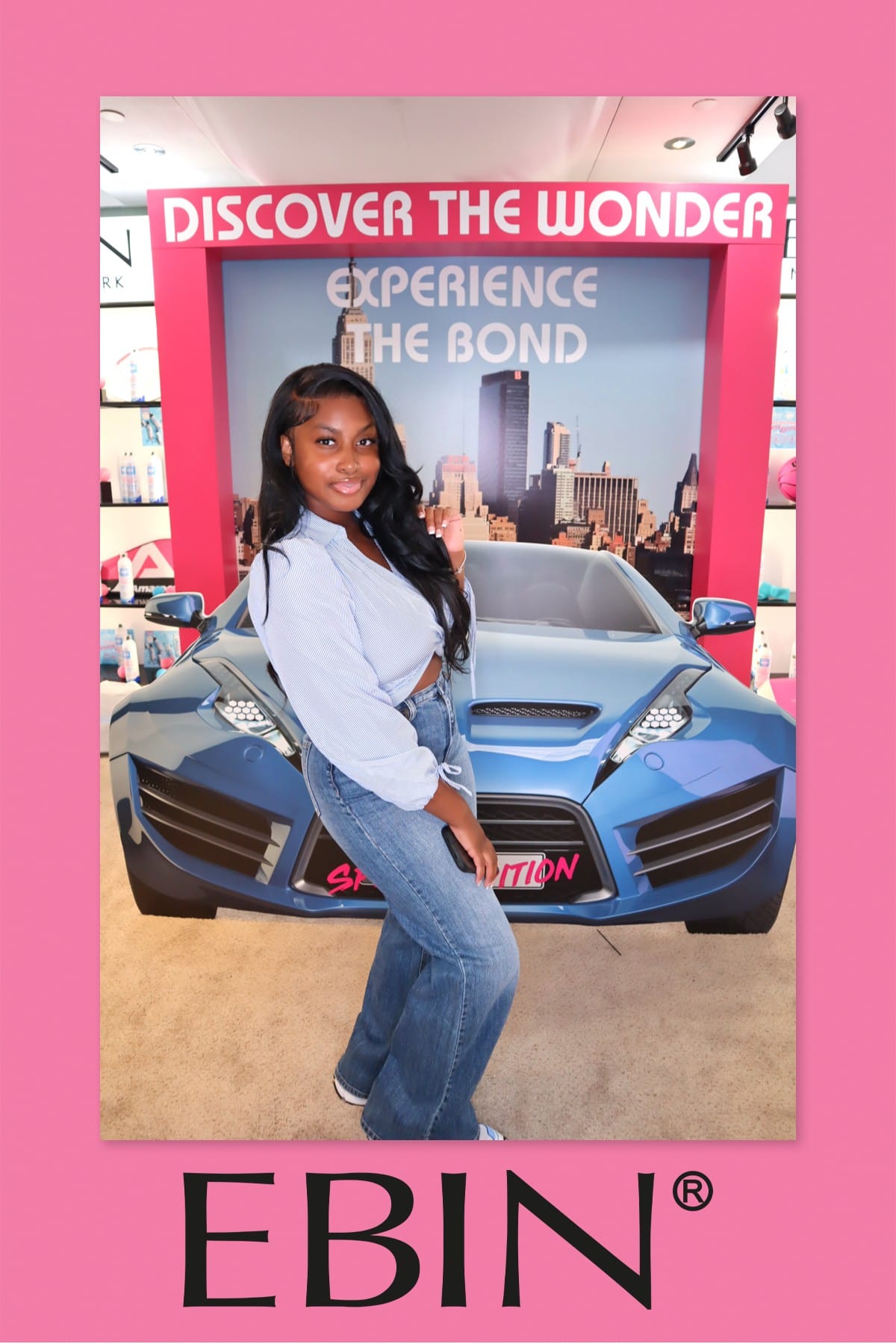Guest posing solo at the EBIN New York sports-car photo prop, striped shirt