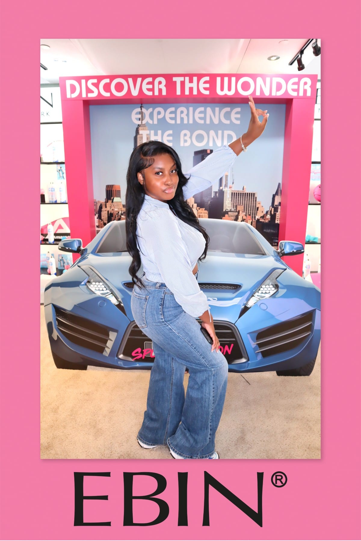 Guest striking a pose at the EBIN New York Discover the Wonder backdrop