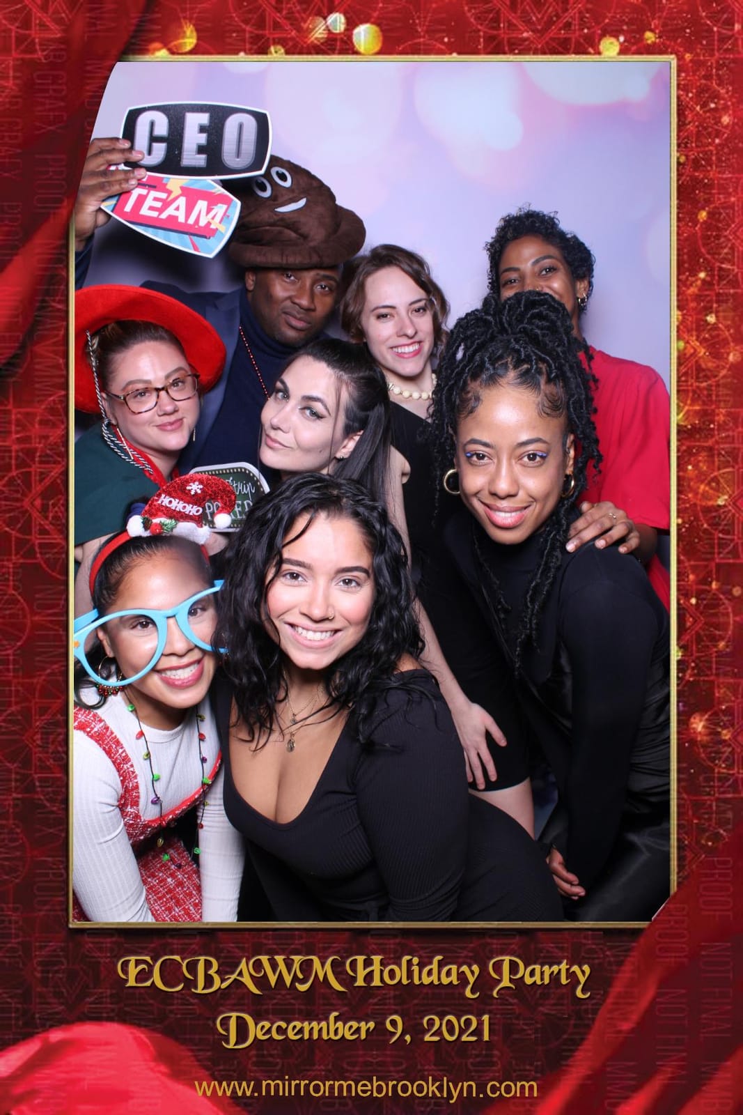 Colleagues celebrating at the ECBAWM Holiday Party photo booth