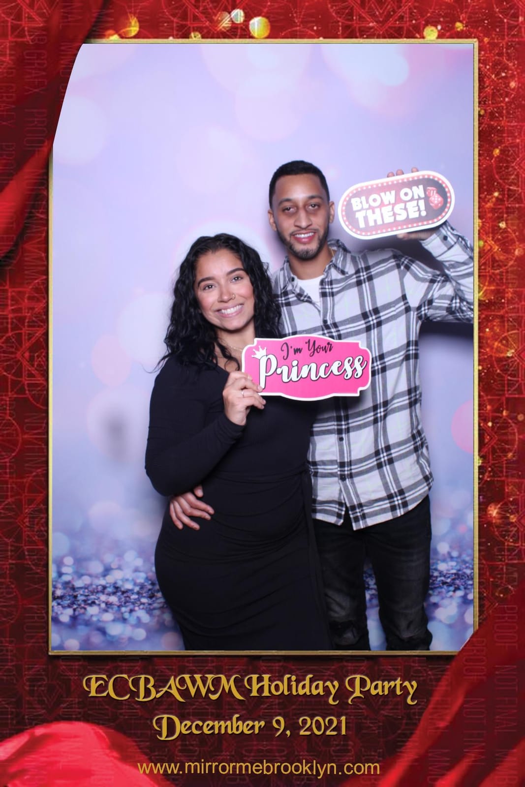 Guests celebrating at the ECBAWM Holiday Party photo booth