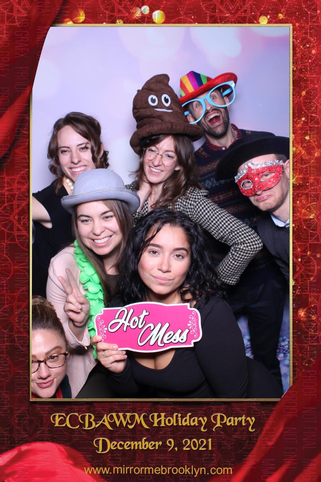 Colleagues celebrating at the ECBAWM Holiday Party photo booth
