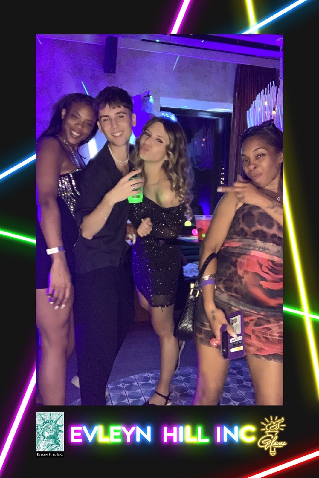 Four guests posing for the roaming booth at the Evelyn Hill Inc glow party