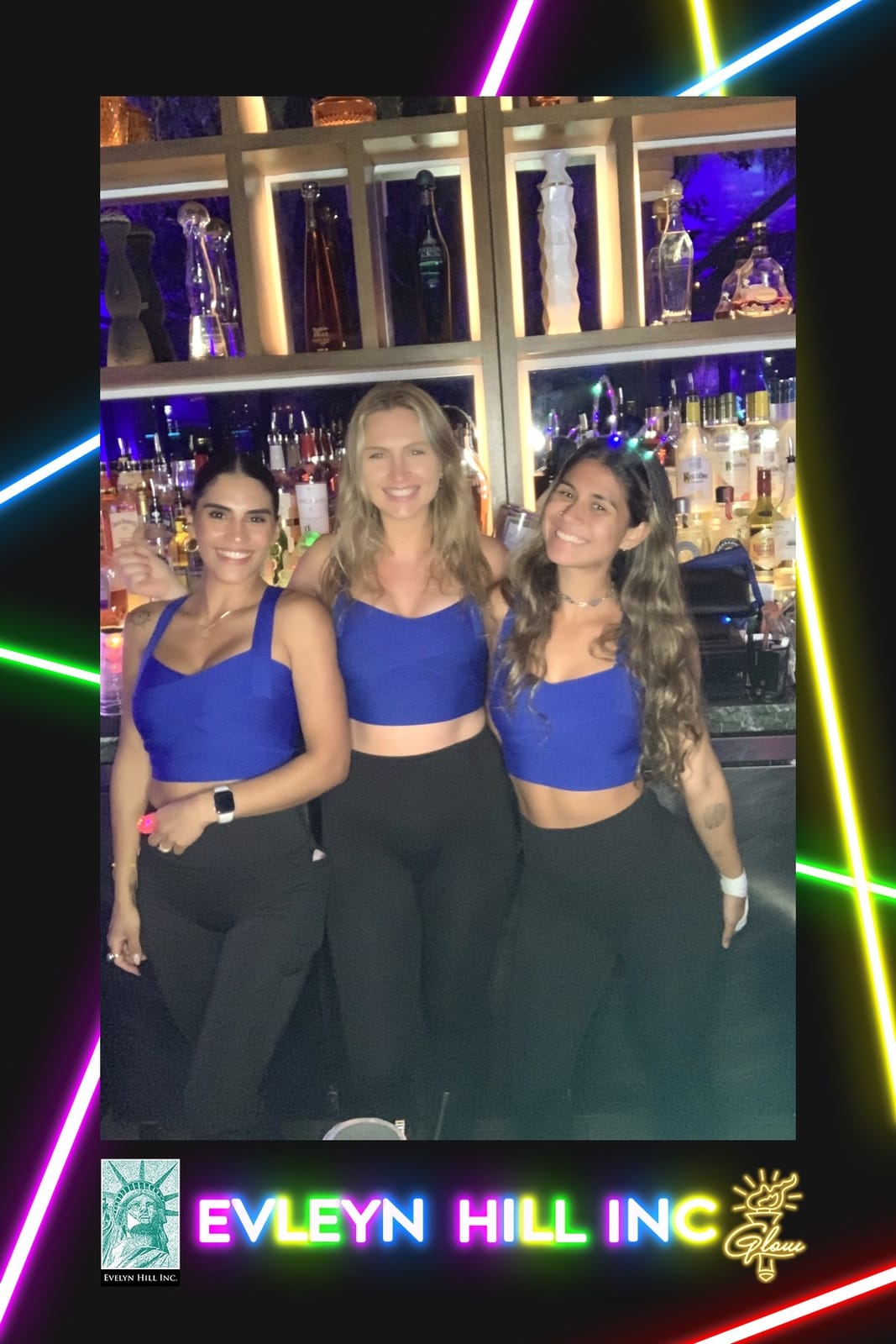 Three bartenders posing at the bar during the Evelyn Hill Inc company dinner