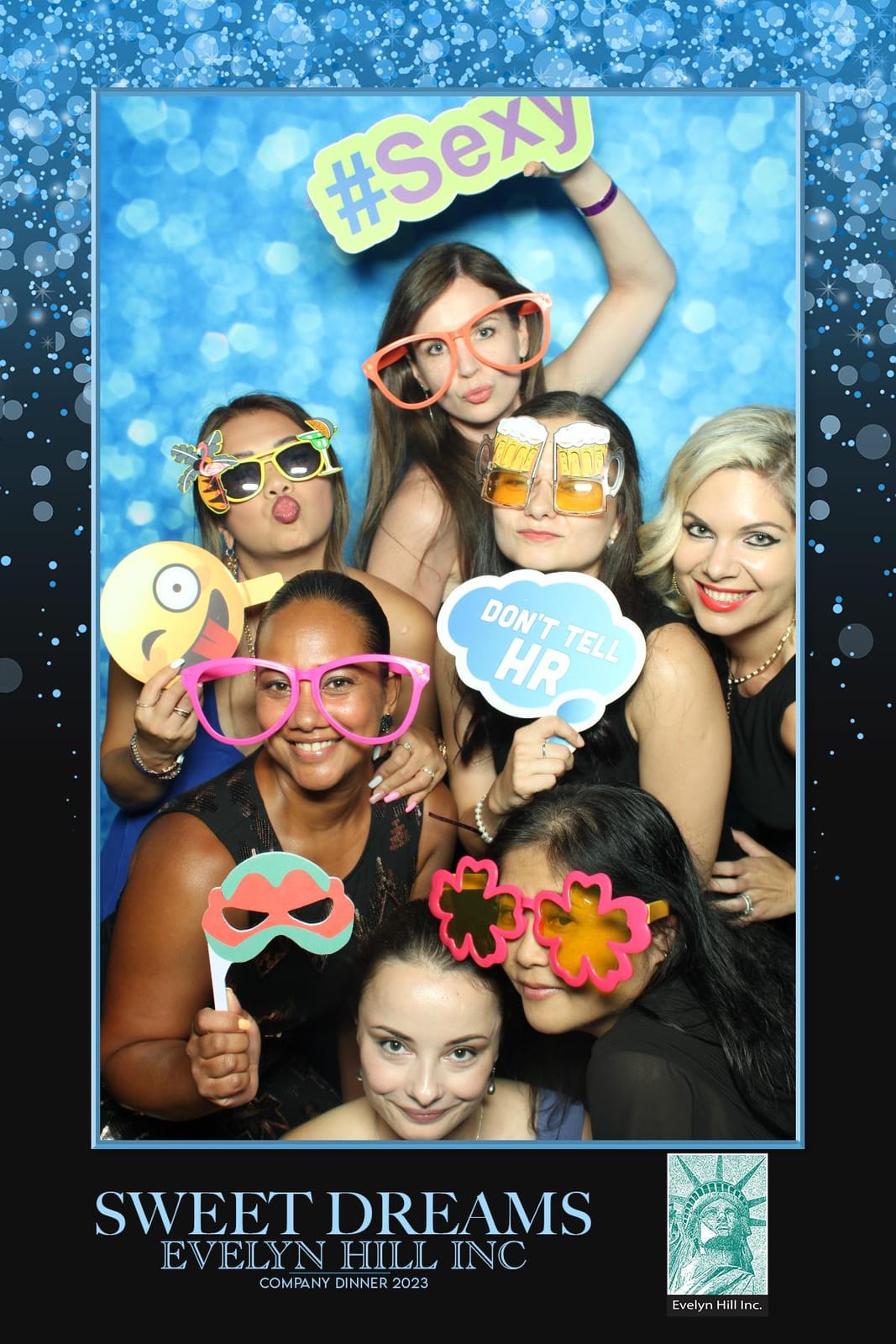 Colleagues posing at the Evelyn Hill Sweet Dreams booth
