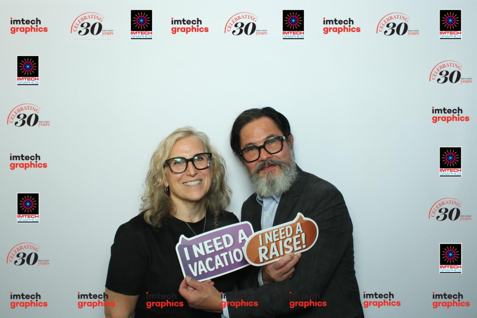 Colleagues posing at the Imtech Graphics anniversary photo booth