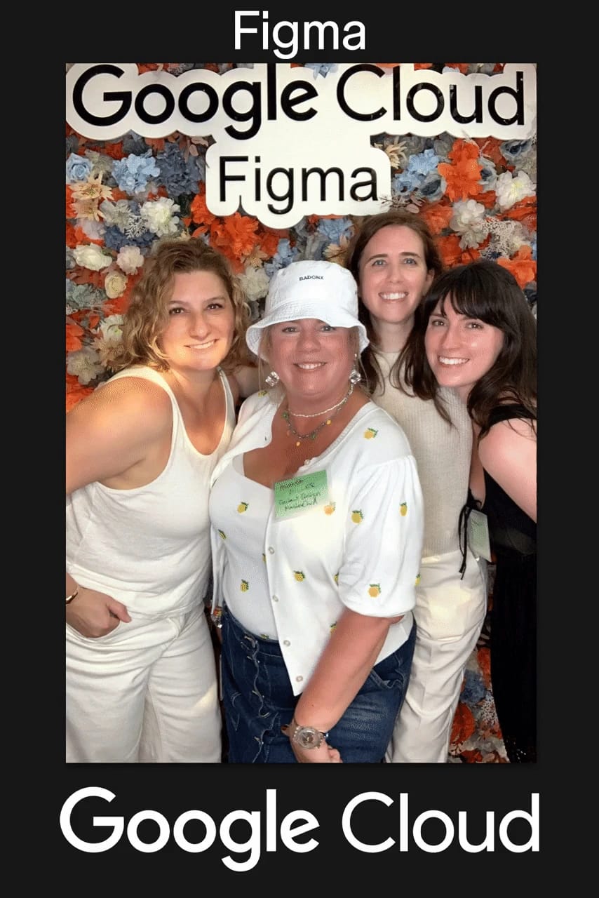 Two guests posing with paper fans — custom Google Cloud × Figma print frame