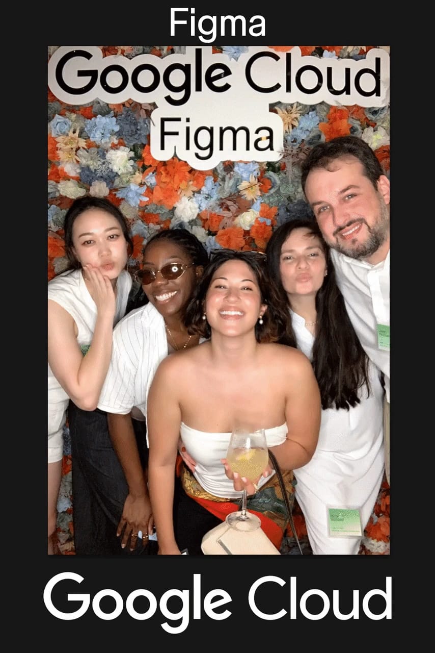 Guest posing solo in front of the flower wall — Google Cloud × Figma branded print