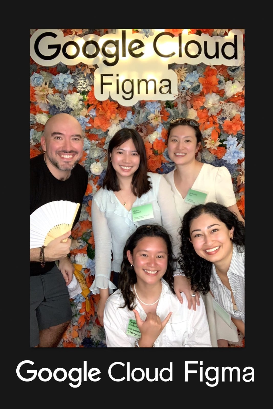 Five colleagues with paper fans at the Google Cloud × Figma booth