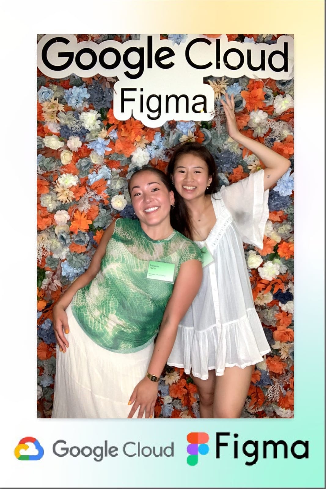 Two friends striking a playful pose at the Google Cloud × Figma flower wall