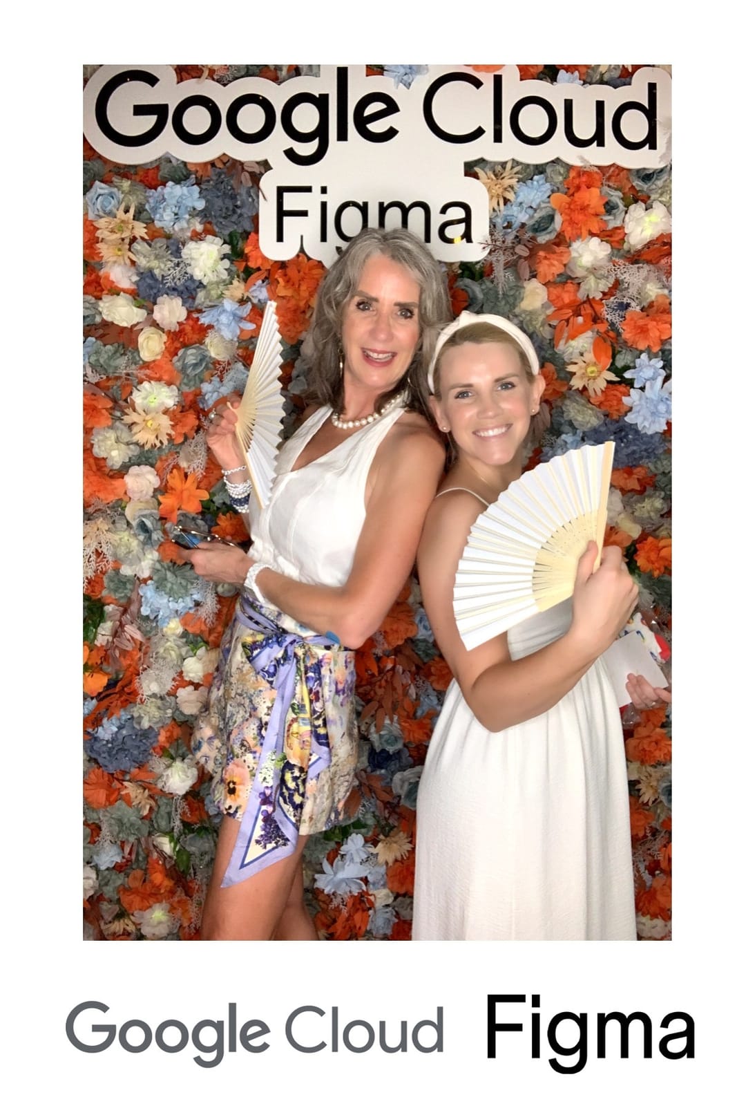 Two guests posing back to back with fans at the Google Cloud × Figma event