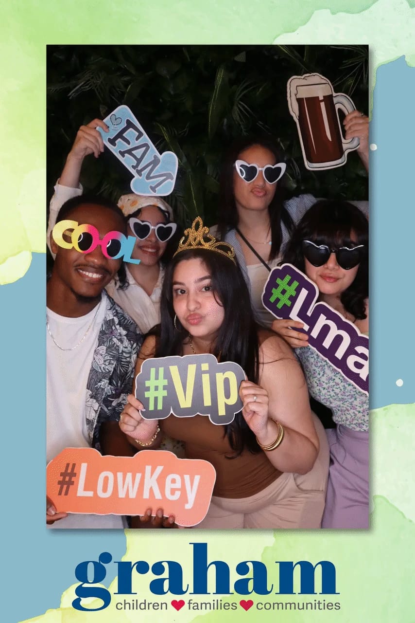 Friends loaded up with hashtag props at the Graham celebration