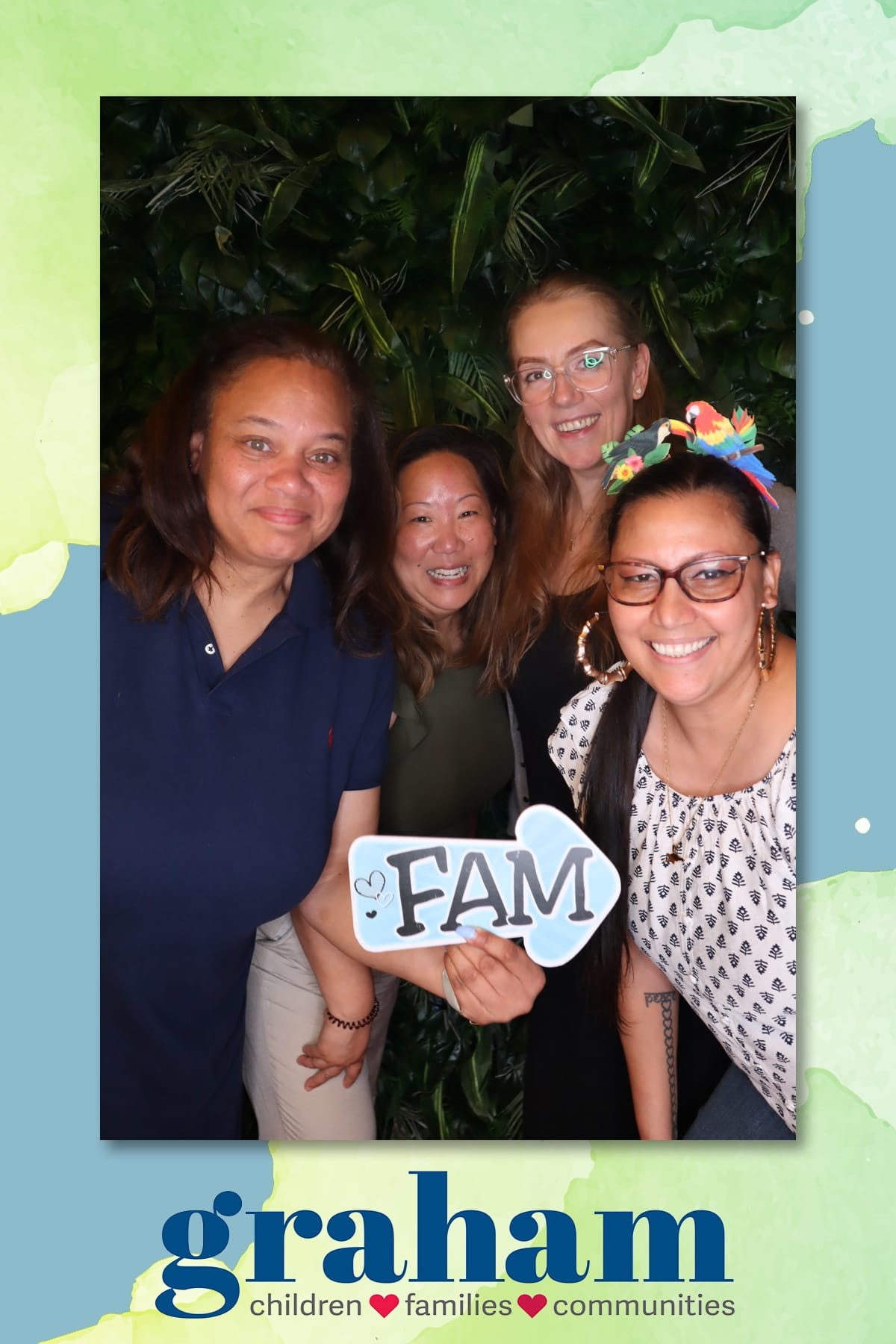 Colleagues with a FAM sign at the Graham staff celebration