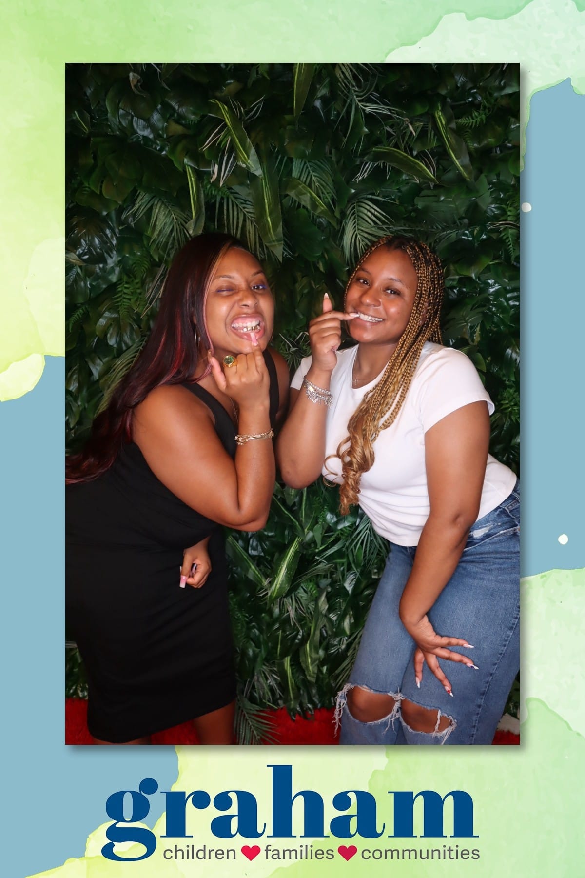 Two friends joking around at the Graham celebration photo booth