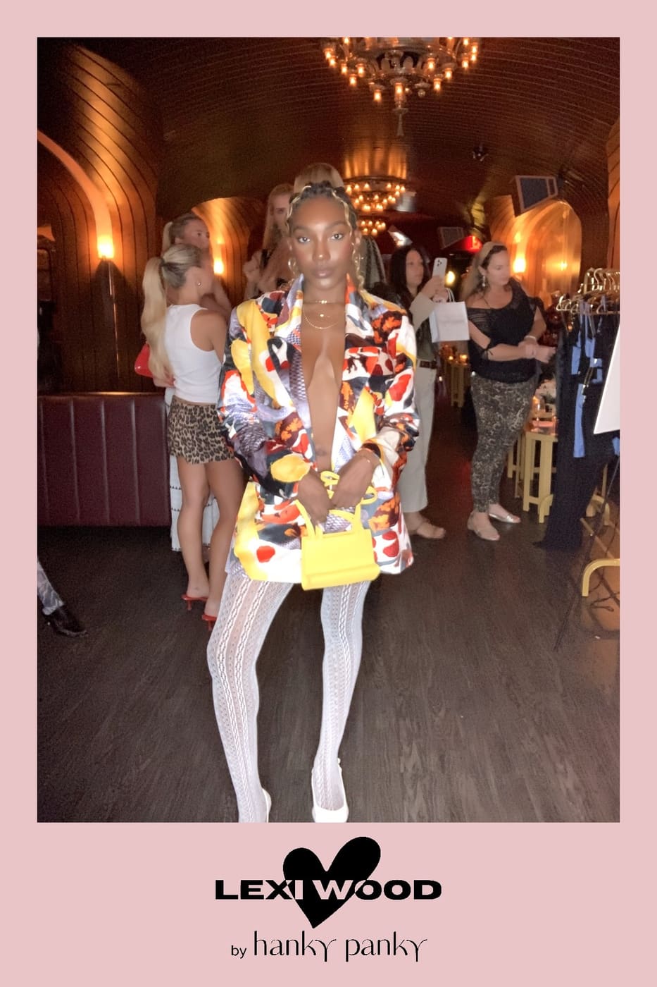 Guest in a colorful print blazer with a yellow mini bag