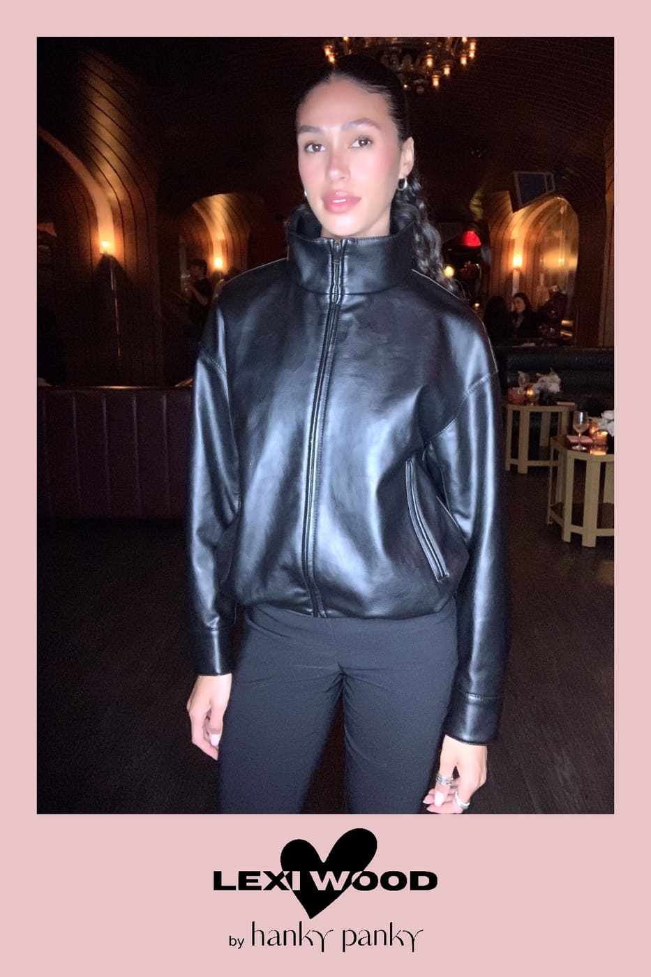 Guest in a black faux-leather bomber jacket at the launch party