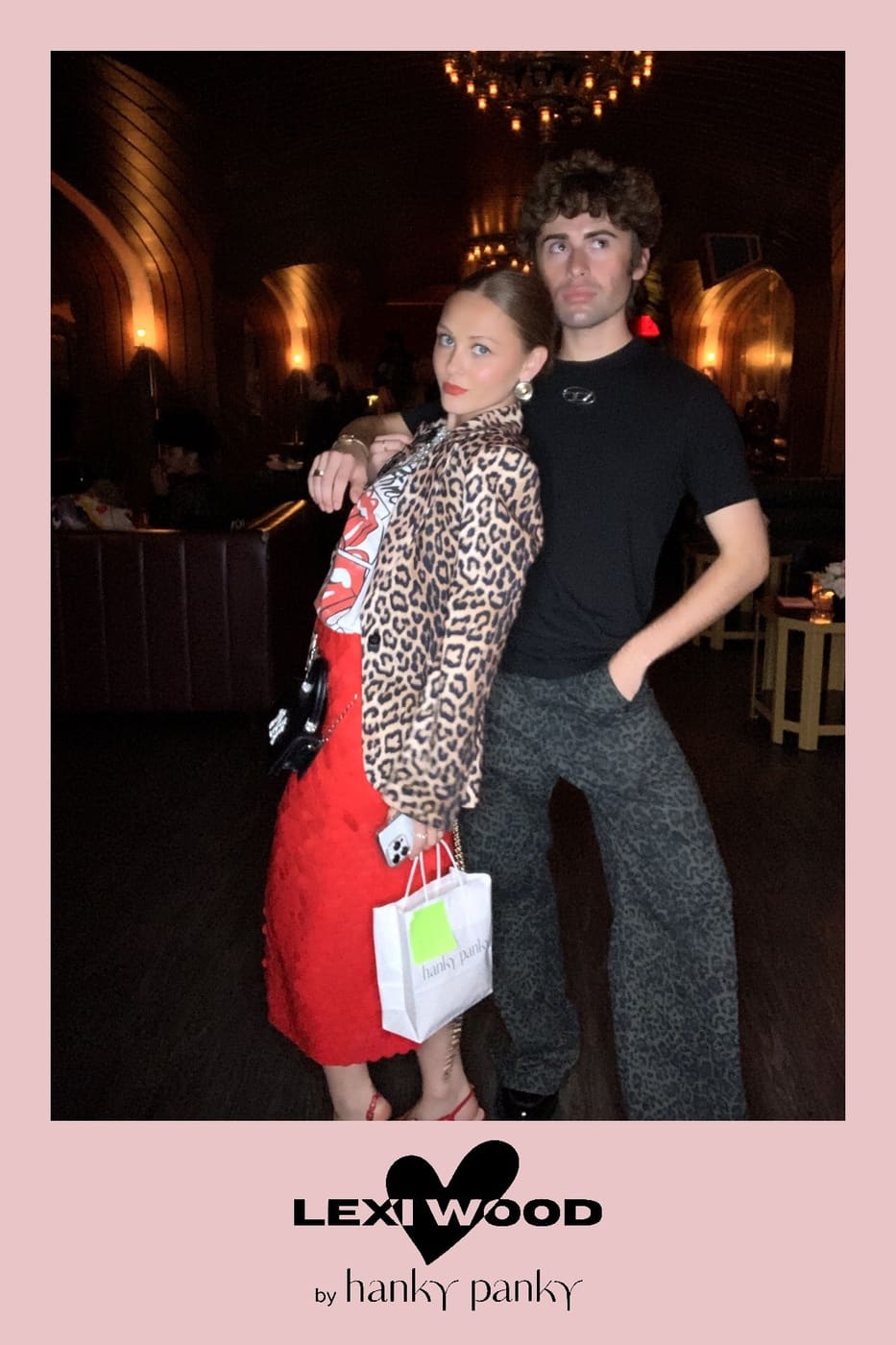 Couple posing back to back — leopard jacket and graphic tee
