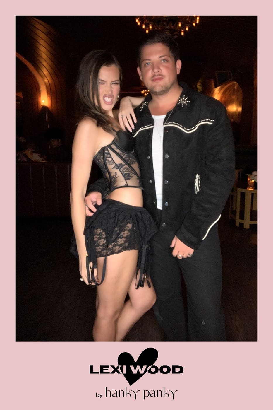 Couple posing at the booth — lace corset and studded western jacket