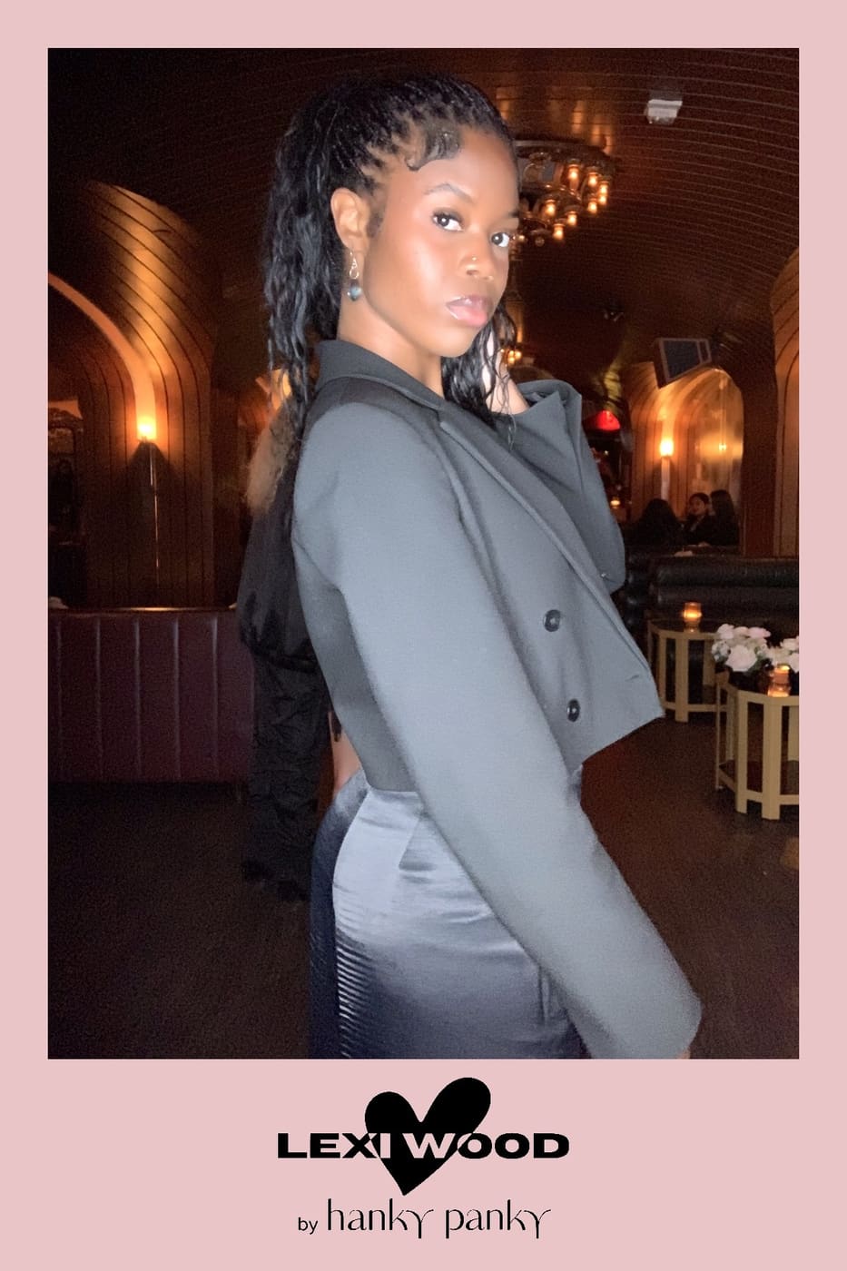 Side profile pose in a cropped gray blazer at the launch