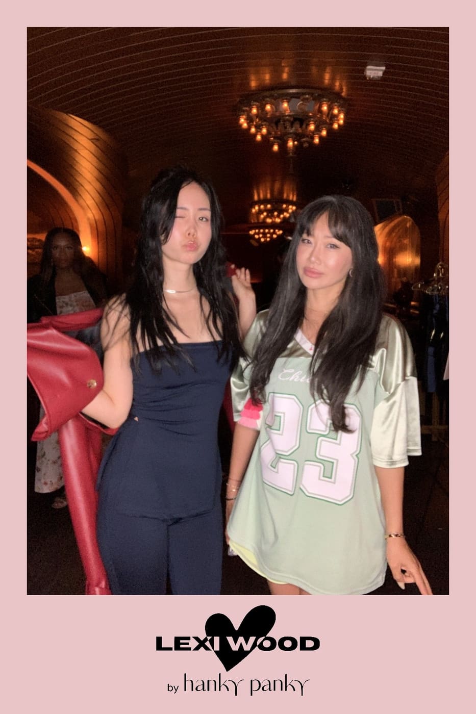 Two friends striking a playful pose at the Lexi Wood launch