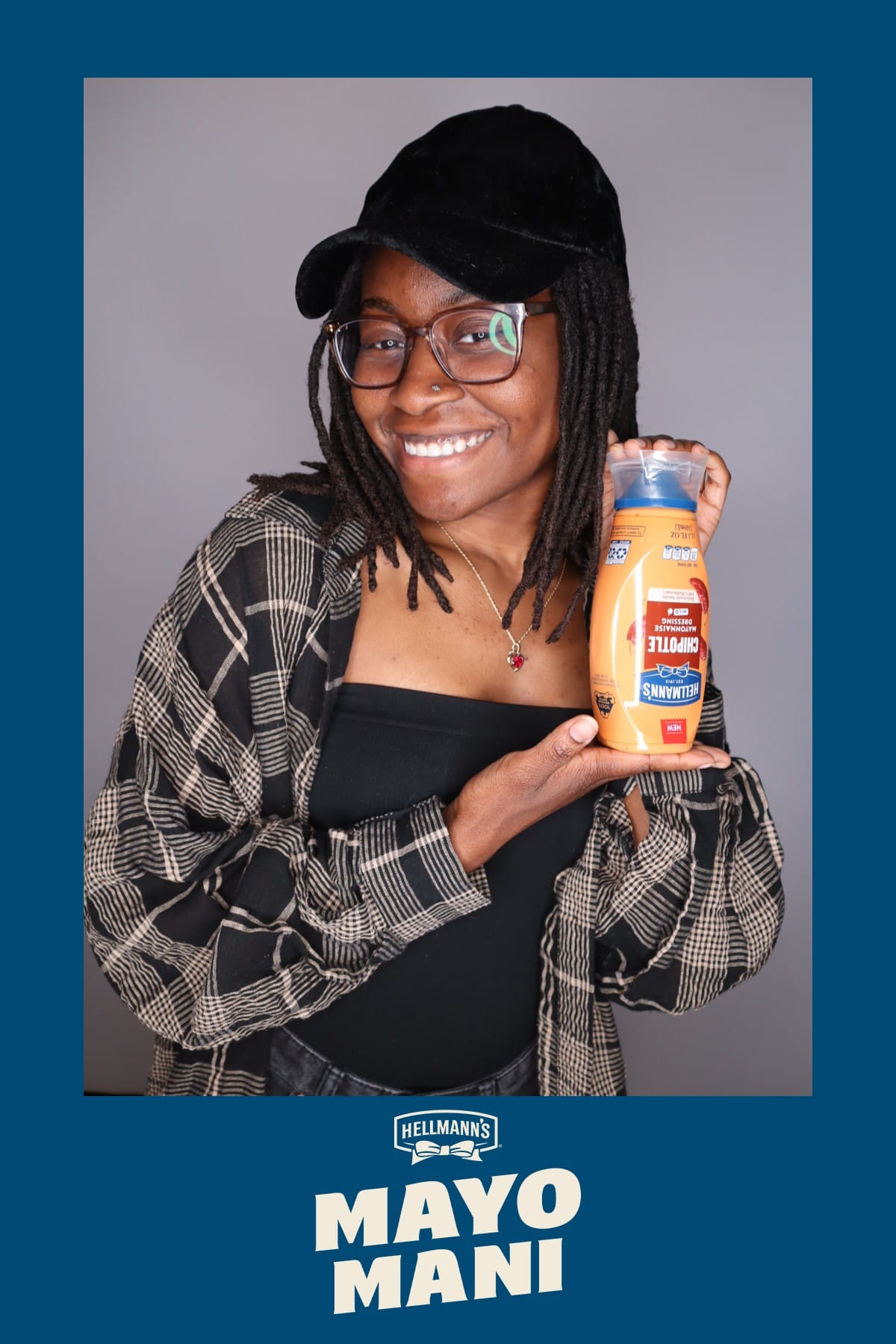 Guest holding a bottle of Hellmann's Chipotle Mayonnaise Dressing at the Mayo Mani photo booth
