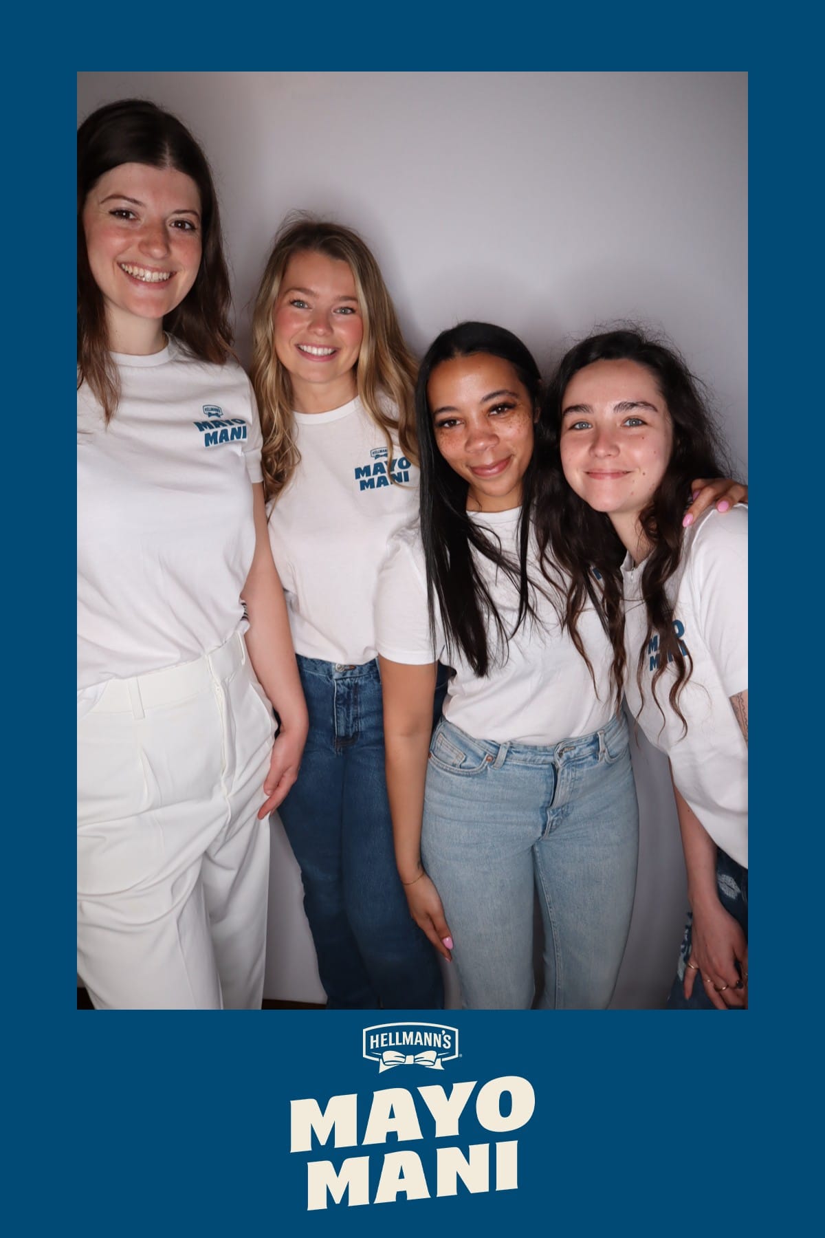 Four friends in matching Mayo Mani t-shirts posing together